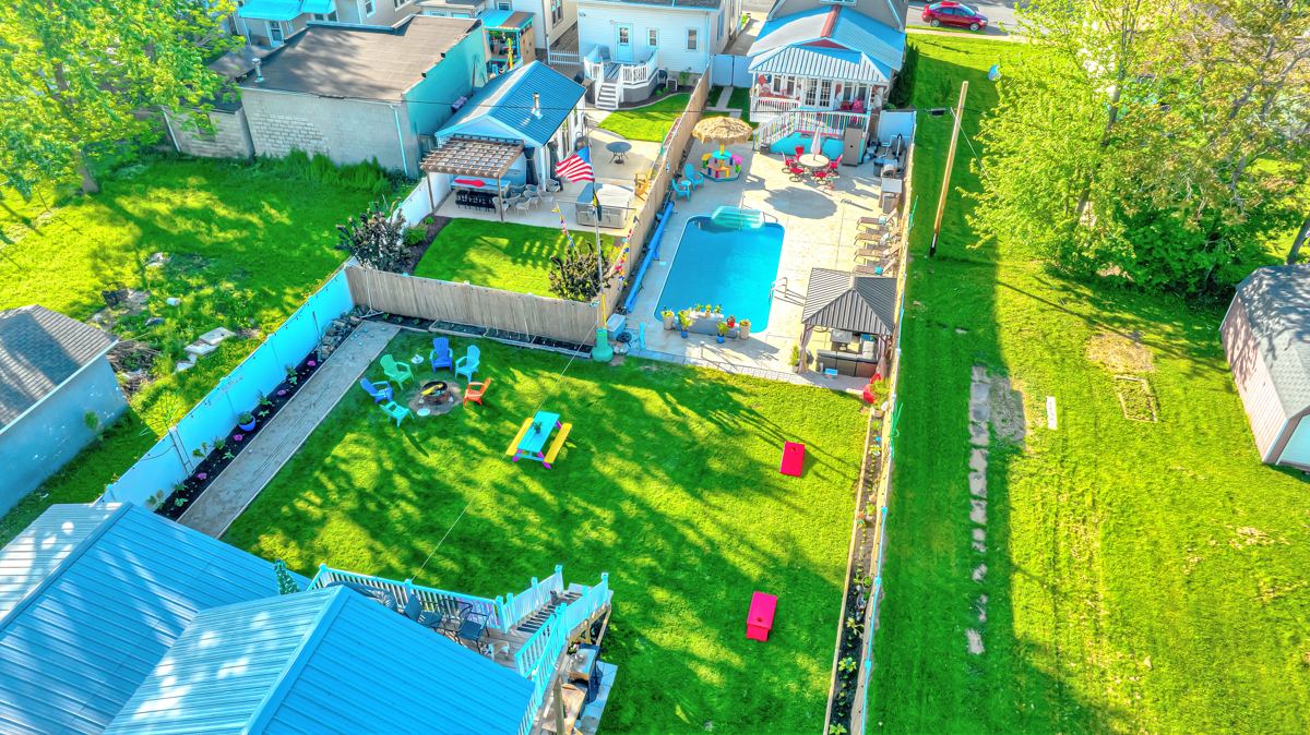 Aerial view of both backyards and shared pool